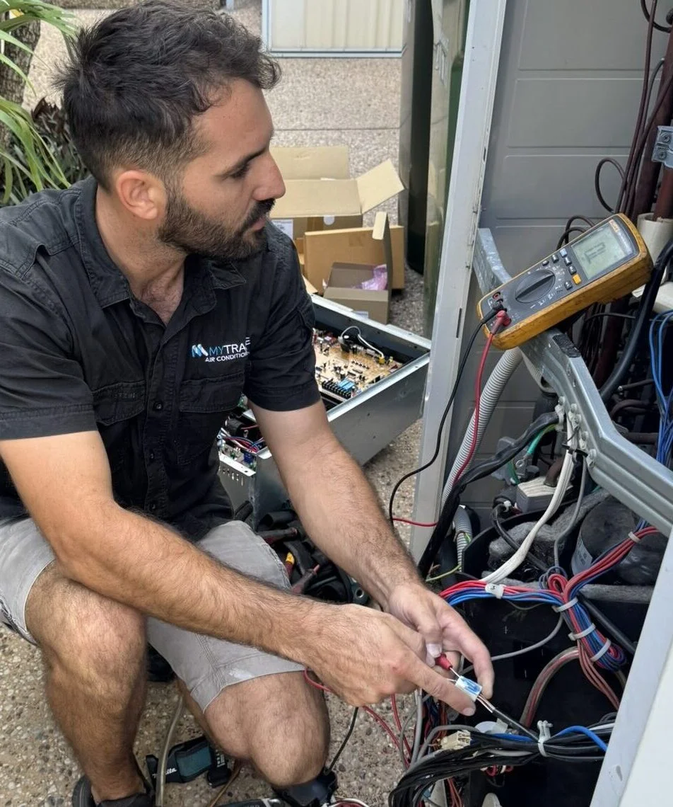 MyTradie Air Conditioning technician testing electrical components with a multimeter during an air conditioning repair service in Sydney